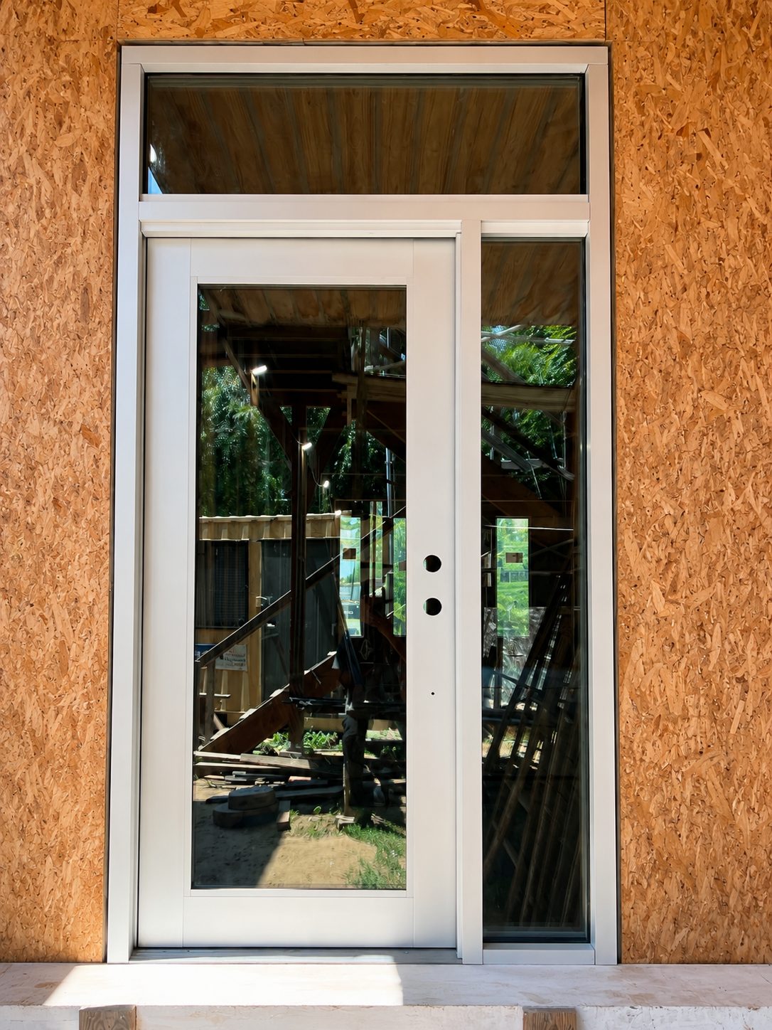 White aluminum entry door with sidelight and transom